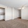 a room with a window and ceiling fan